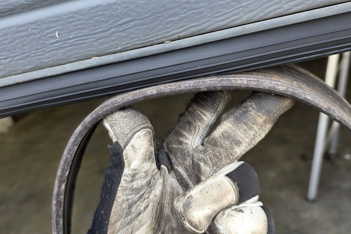 Old garage door weather seal removed during a weatherstripping replacement