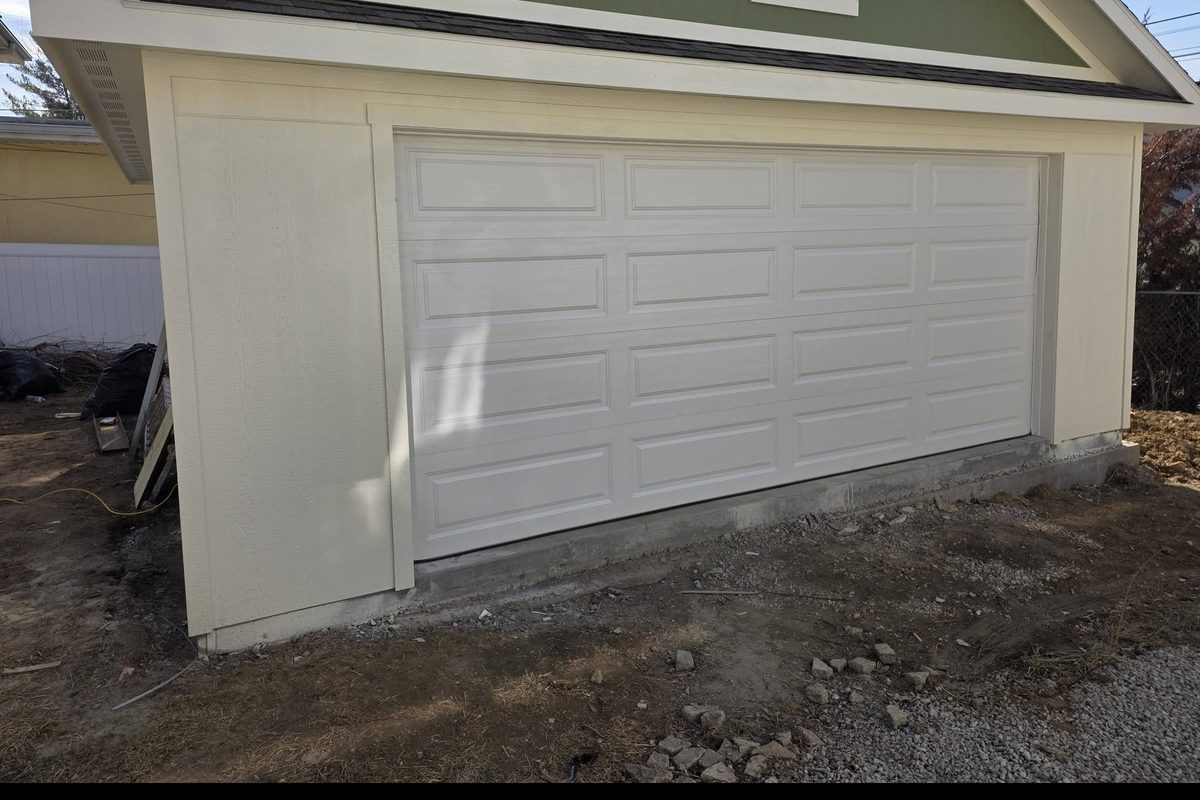New two-car garage door installed on a new garage build