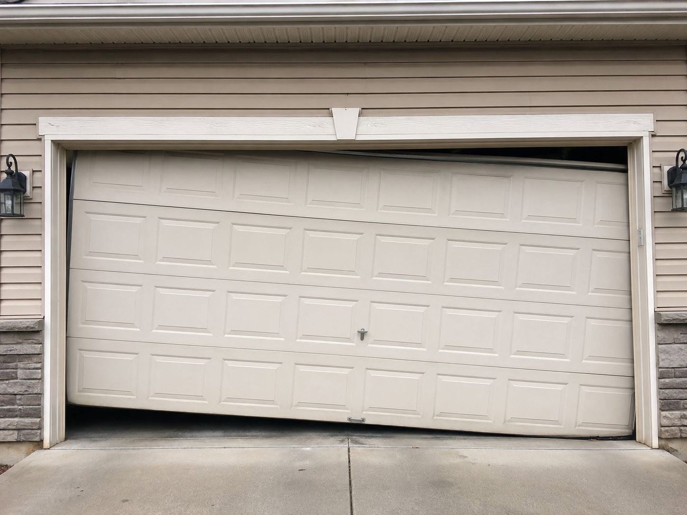 Garage door hanging crooked off its track before repair