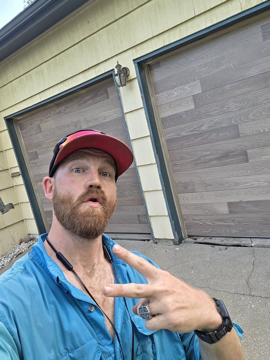 Zach Wallace with a wood-look plank door he installed
